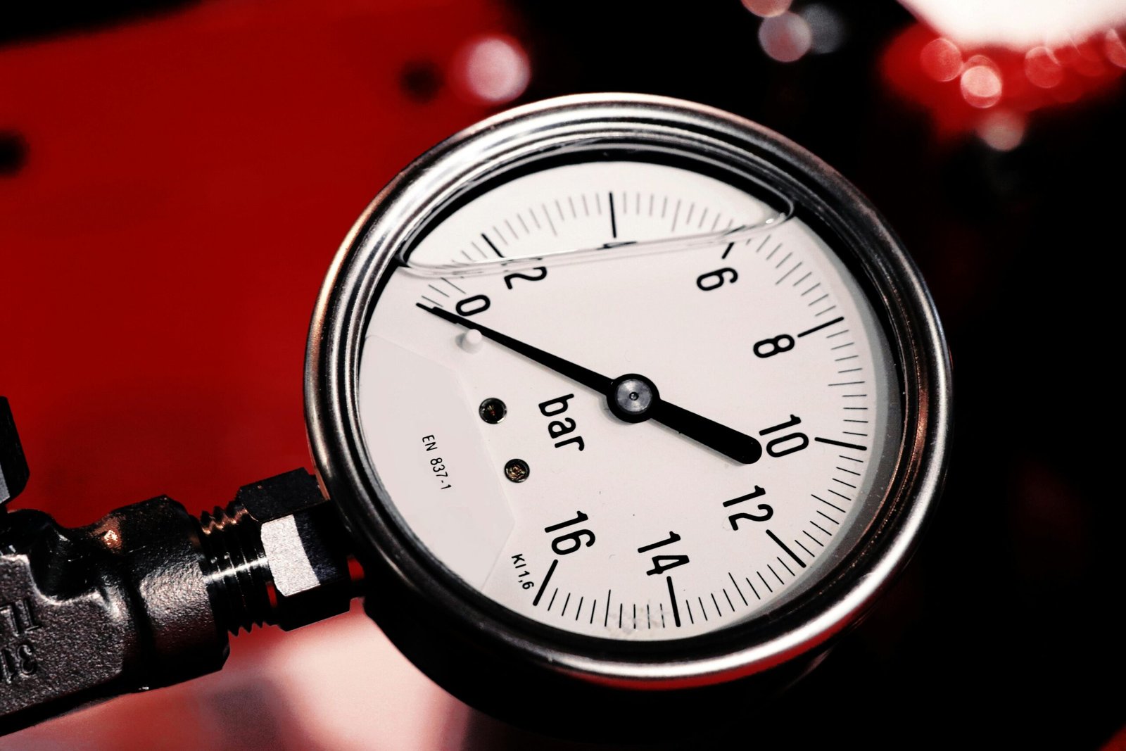 Detailed view of a bar pressure gauge used in industrial settings, emphasizing precision and measurement.